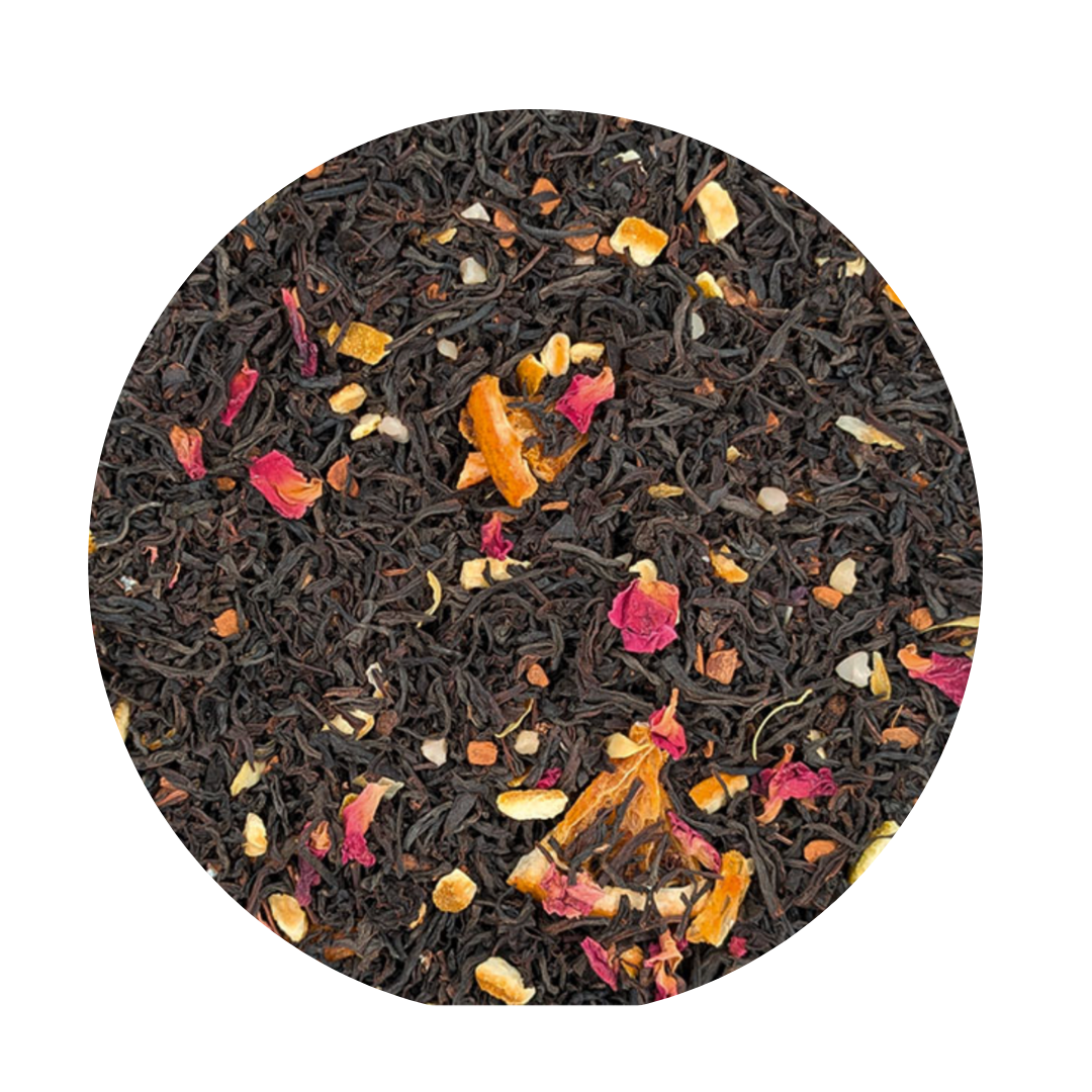 Round container of black tea with floral and fruit pieces on a white background