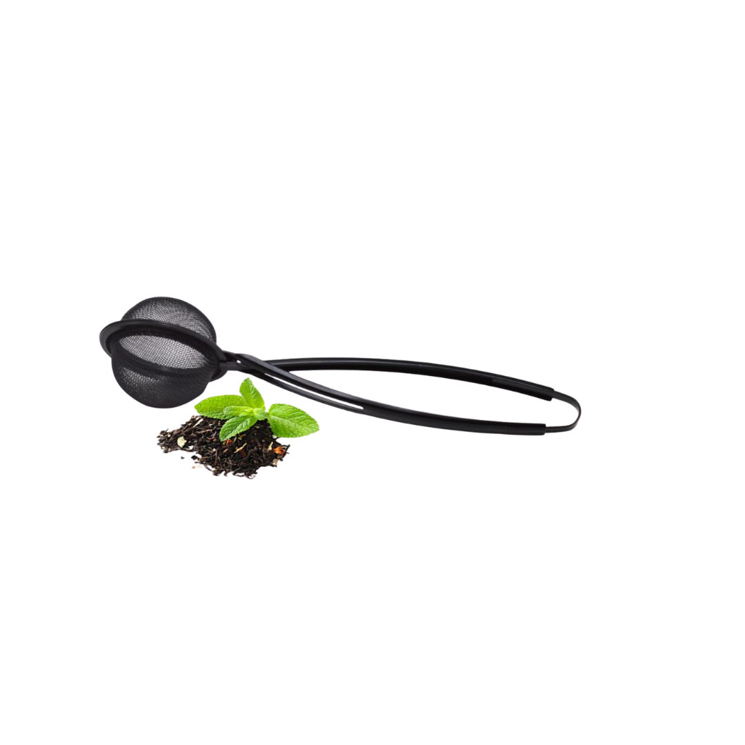 Black tea infuser tongs with tea leaves and mint leaves on a white background