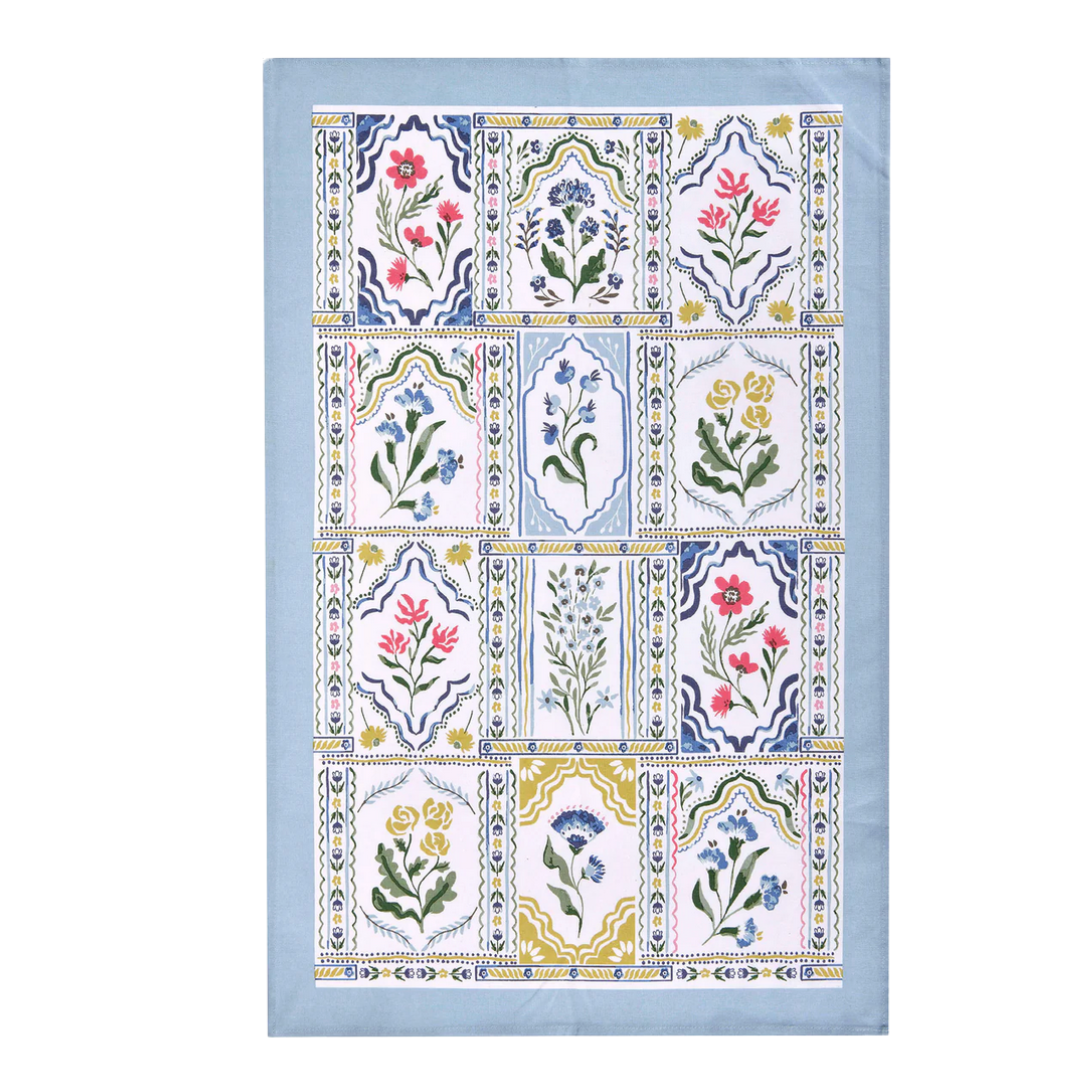 Decorative towel with floral and geometric patterns on a light blue background