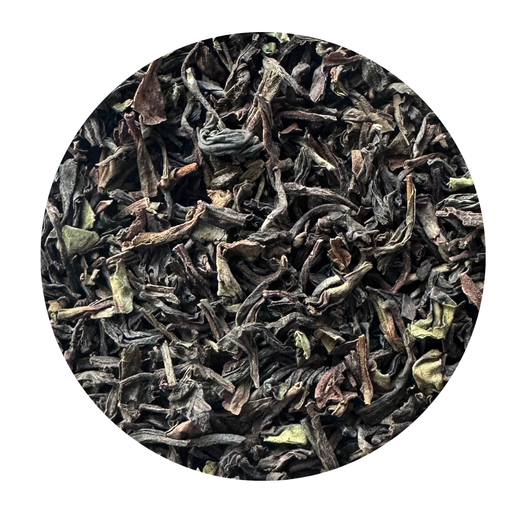 Close-up of dried black tea leaves on a white background