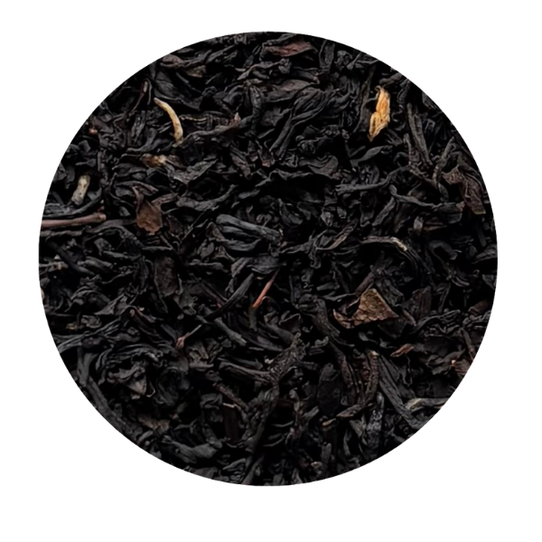 Close-up of black tea leaves in a circular frame on a white background