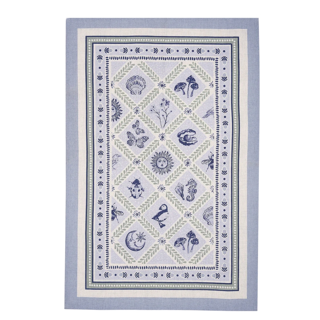 Decorative towel with nature-themed design on a light blue background