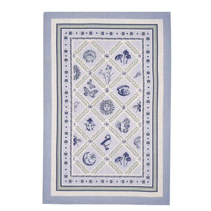 Decorative towel with nature-themed design on a light blue background
