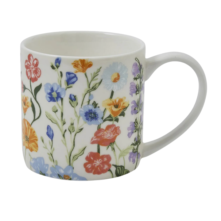 White bone china mug with colorful floral pattern on a white background