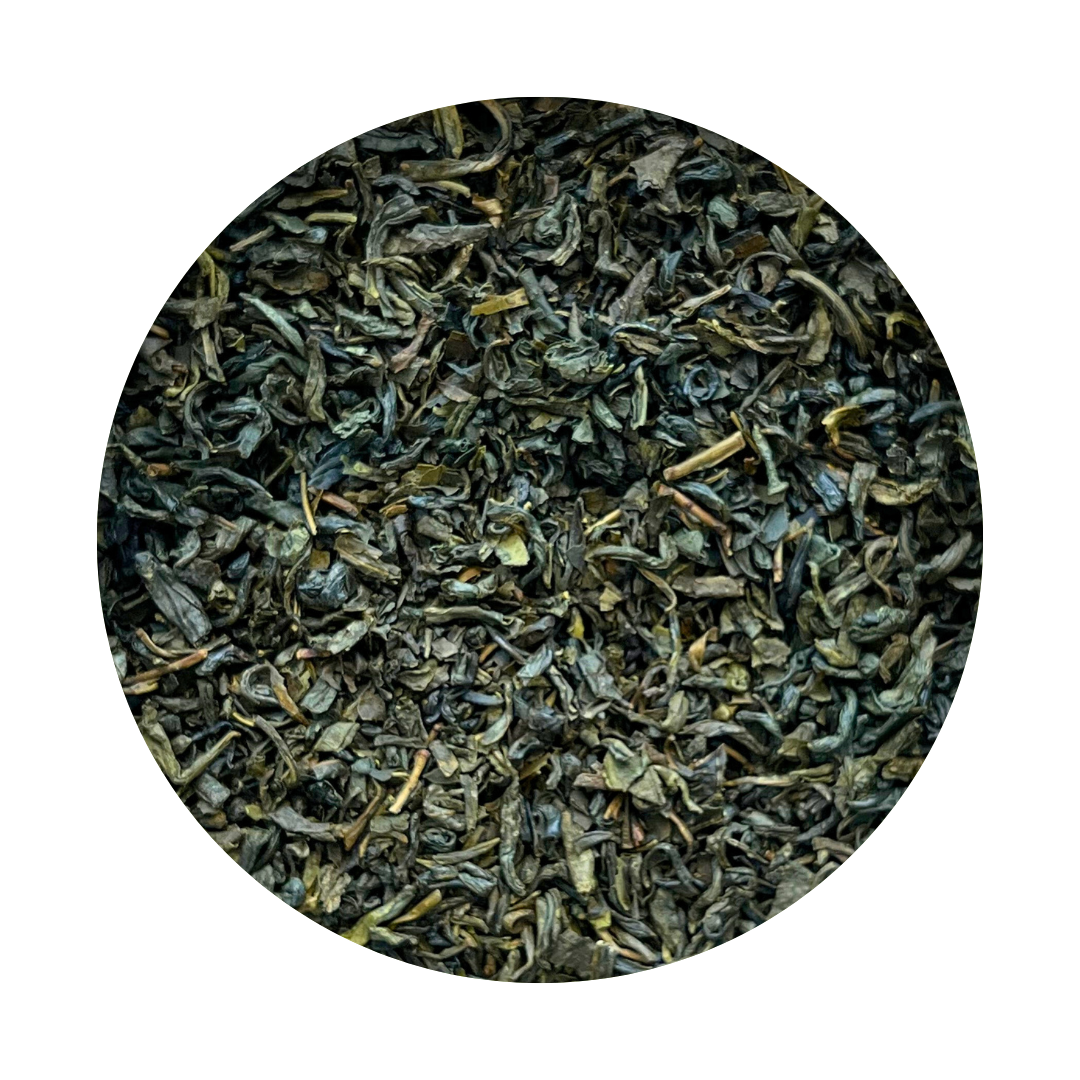 Loose leaf green tea mixed with smaller leaf pieces, indicative of a tea blend.