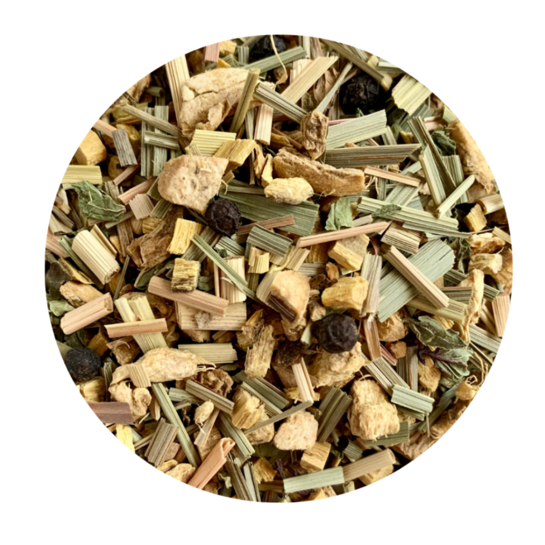 A close-up of loose tea leaves and pieces of herbs, including lemon peel and black pepper, indicative of a spicy herbal tea blend.