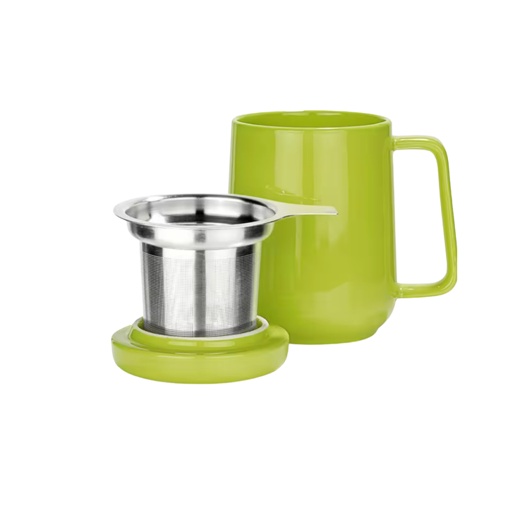 Green porcelain mug with lid and tea infuser on a white background