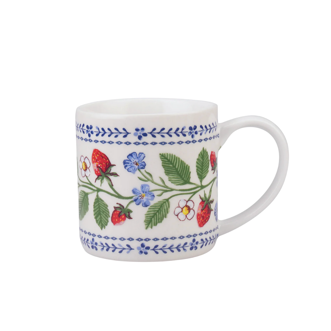 White mug with floral and strawberry pattern on a white background