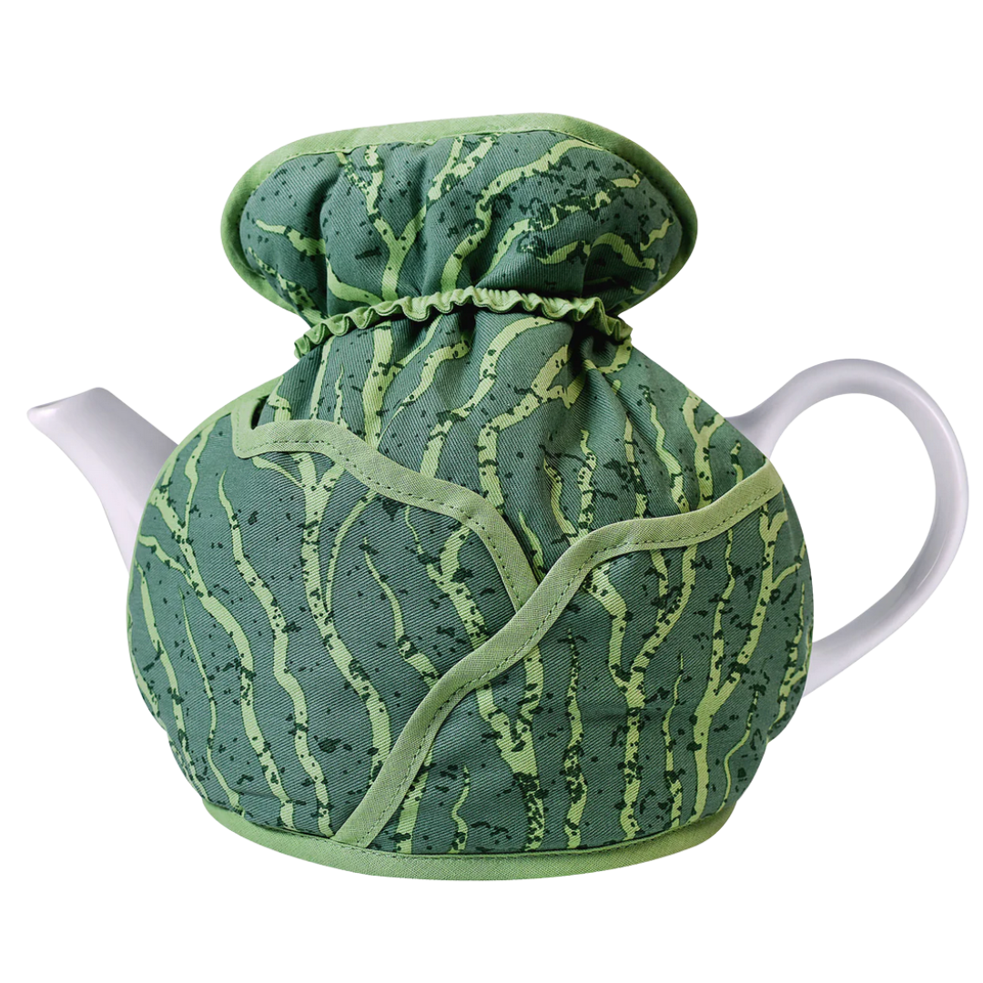 Tea pot with a green patterned cover on a white background