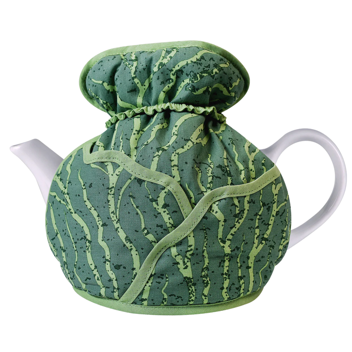 Tea pot with a green patterned cover on a white background