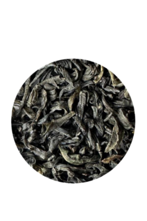 A circular close-up of dark, curly dried tea leaves on a solid white background.