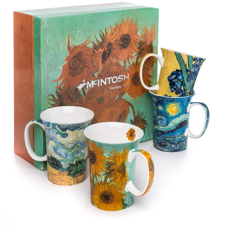 A set of four fine bone china mugs with printed art, displayed in front of a box featuring another of the artist&